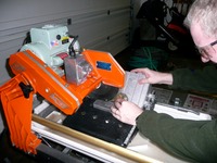 Greg using a tile saw with a thunder egg